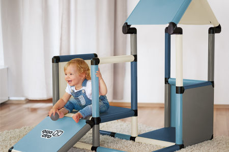 Child sitting on a playhouse ramp